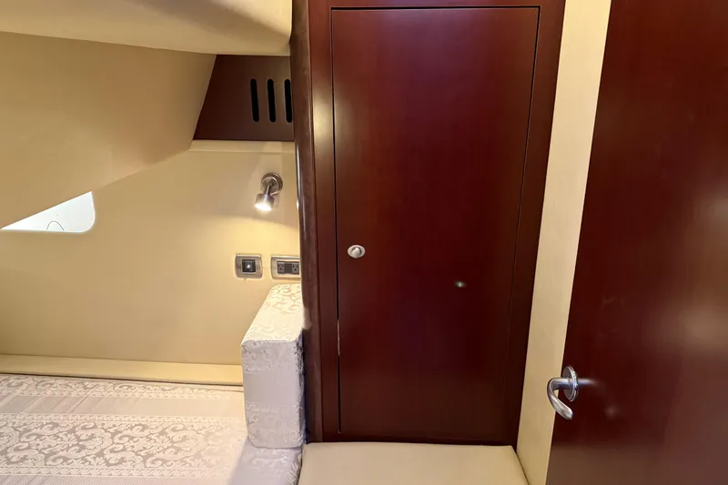  Yacht Photos Pics Interior of 2006 Sea Ray 44 Sedan Bridge with wood paneling and cozy lighting.