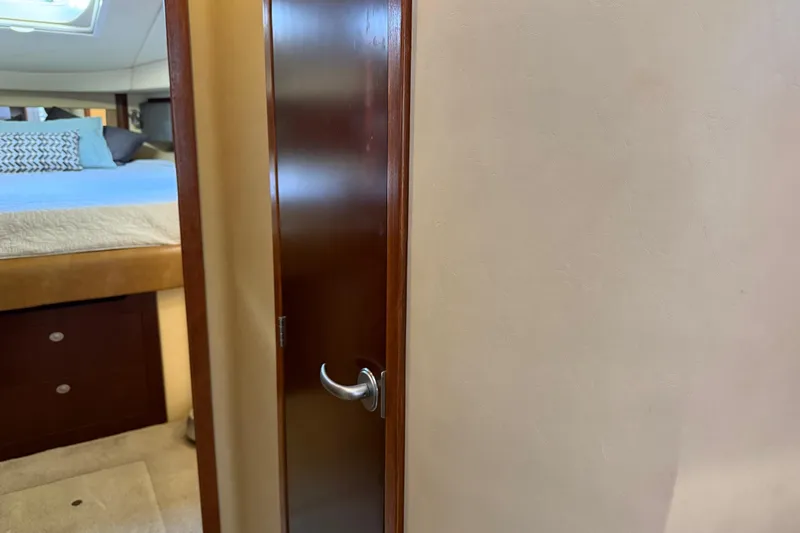  Yacht Photos Pics Interior view of 2006 Sea Ray 44 Sedan Bridge, featuring a bedroom and wooden door.