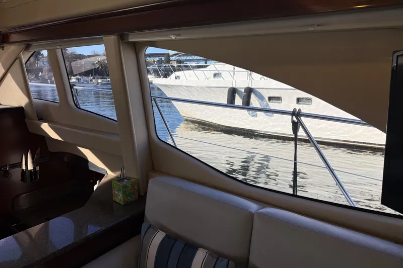  Yacht Photos Pics Interior view of 2006 Sea Ray 44 Sedan Bridge yacht with marina backdrop.