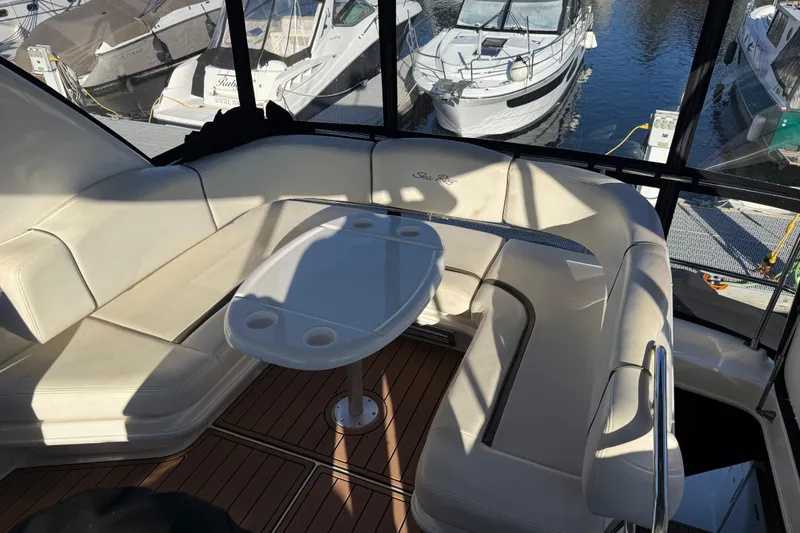  Yacht Photos Pics Luxurious 2006 Sea Ray 44 Sedan Bridge yacht interior with white seating and table.