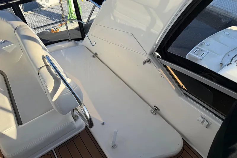  Yacht Photos Pics 2006 Sea Ray 44 Sedan Bridge interior with white seating and polished railings.