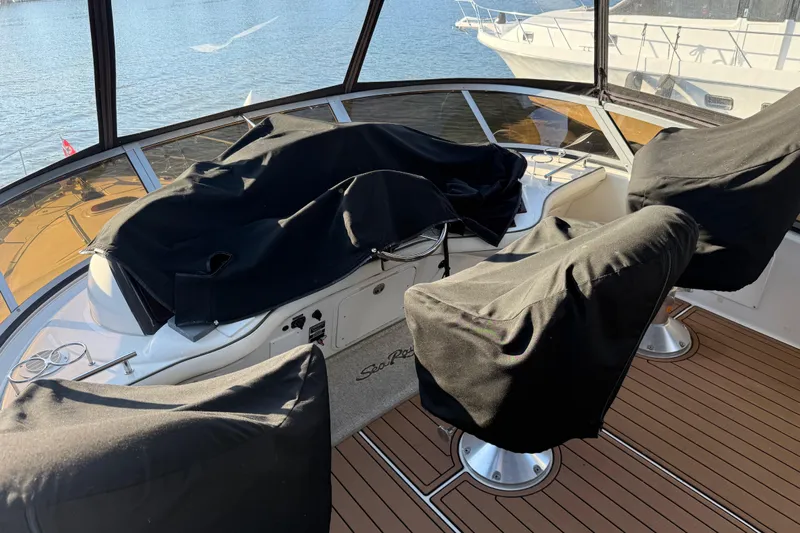  Yacht Photos Pics 2006 Sea Ray 44 Sedan Bridge helm with covered seats, overlooking water.