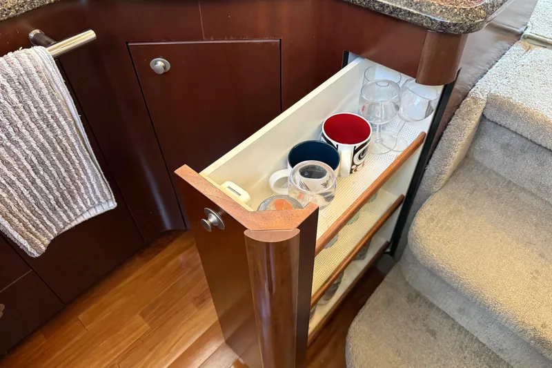  Yacht Photos Pics Pull-out cabinet with mugs and glasses in 2006 Sea Ray 44 Sedan Bridge yacht.