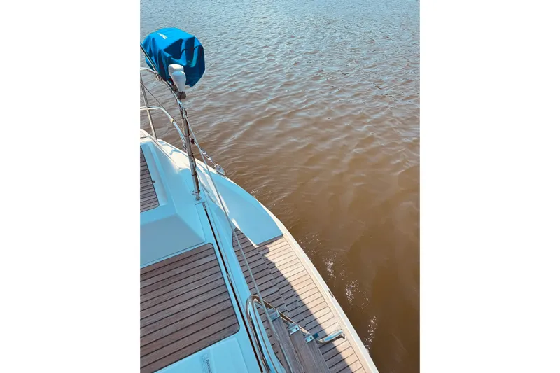 Bluefin Yacht Photos Pics Jeanneau Sun Odyssey 45 DS sailboat deck, 2008 model, overlooking calm water.