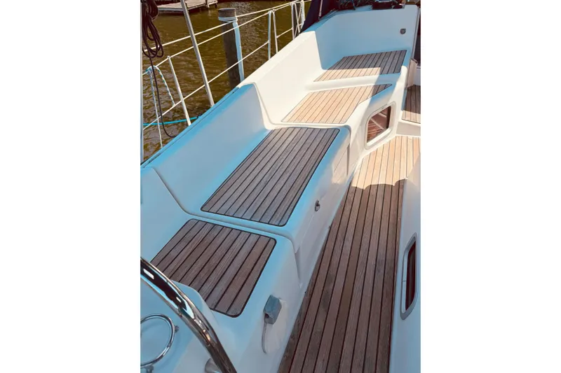 Bluefin Yacht Photos Pics 2008 Jeanneau Sun Odyssey 45 DS yacht deck with teak seating and railing.