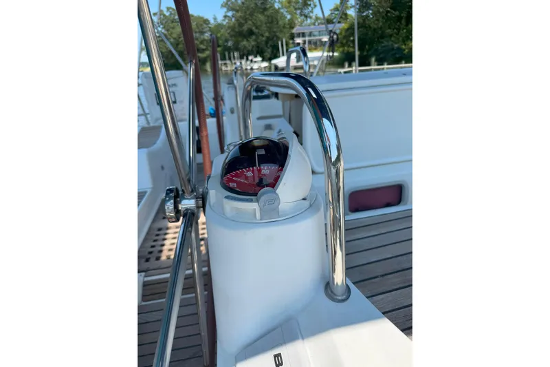 Bluefin Yacht Photos Pics Compass on Jeanneau Sun Odyssey 45 DS yacht, 2008 model, with wooden deck background.