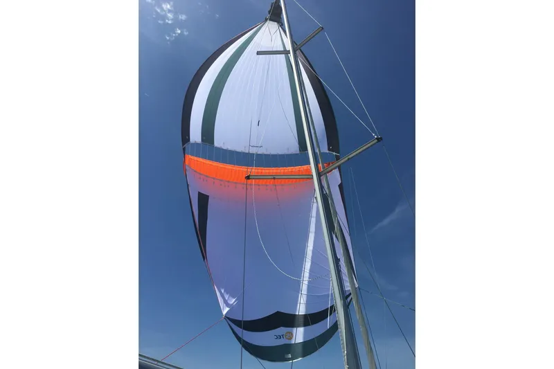 Bluefin Yacht Photos Pics Sail of 2008 Jeanneau Sun Odyssey 45 DS against clear blue sky.