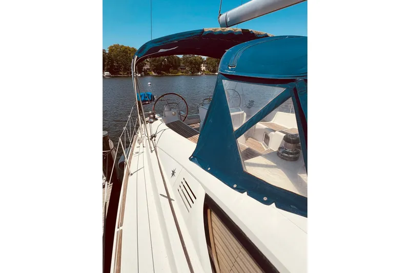 Bluefin Yacht Photos Pics 2008 Jeanneau Sun Odyssey 45 DS sailboat with blue canopy on a sunny day.