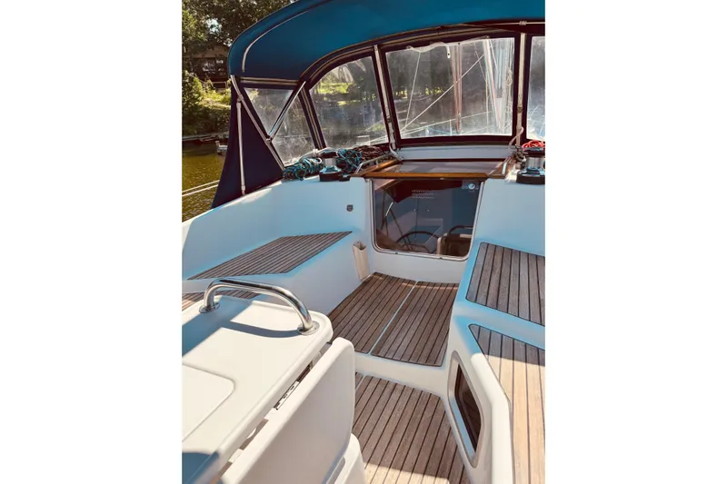 Bluefin Yacht Photos Pics Cockpit of 2008 Jeanneau Sun Odyssey 45 DS sailboat with teak flooring and blue canopy.