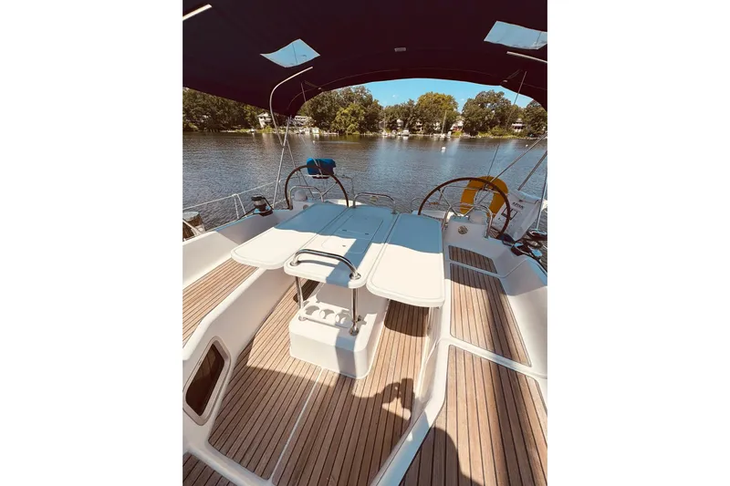Bluefin Yacht Photos Pics Cockpit of 2008 Jeanneau Sun Odyssey 45 DS sailboat with wooden deck and seating.