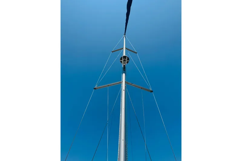 Bluefin Yacht Photos Pics Mast of 2008 Jeanneau Sun Odyssey 45 DS sailboat against clear blue sky.