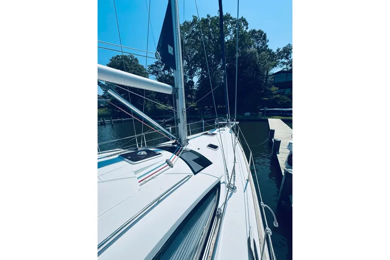 Bluefin Yacht Photos Pics 2008 Jeanneau Sun Odyssey 45 DS sailboat docked by a serene waterfront.