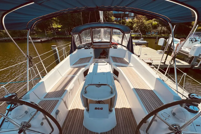 Bluefin Yacht Photos Pics 2008 Jeanneau Sun Odyssey 45 DS sailboat cockpit with dual steering wheels and teak seating.