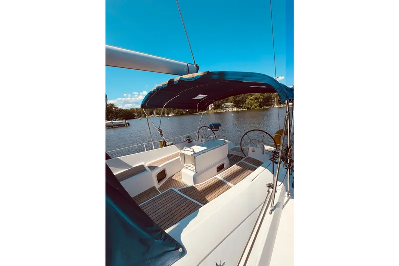 Bluefin Yacht Photos Pics 2008 Jeanneau Sun Odyssey 45 DS sailboat cockpit with blue canopy on a sunny day.