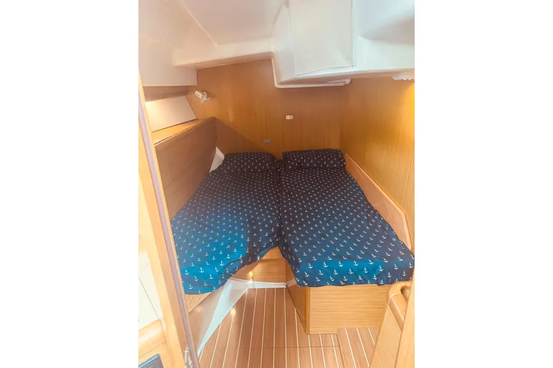 Bluefin Yacht Photos Pics Cozy cabin interior of 2008 Jeanneau Sun Odyssey 45 DS with nautical-themed bedding.