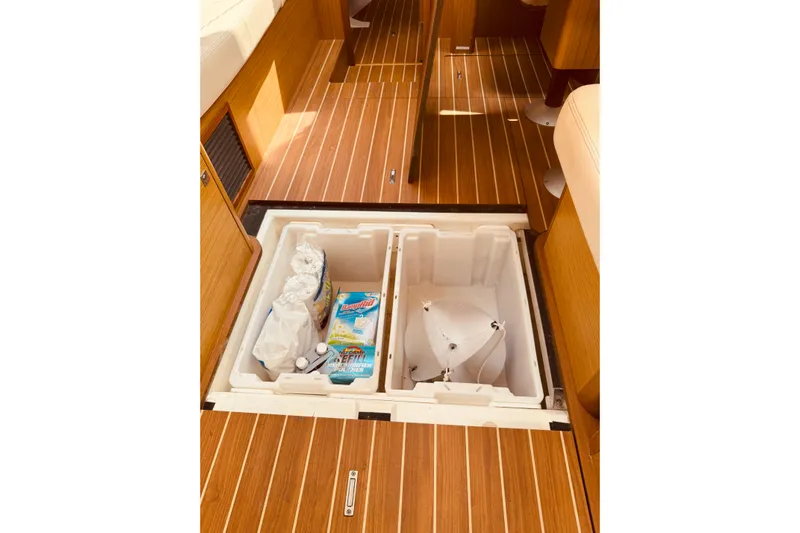 Bluefin Yacht Photos Pics Storage compartment on 2008 Jeanneau Sun Odyssey 45 DS yacht with wooden flooring.
