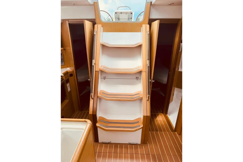 Bluefin Yacht Photos Pics Interior of 2008 Jeanneau Sun Odyssey 45 DS yacht with wooden stairs and cabin doors.