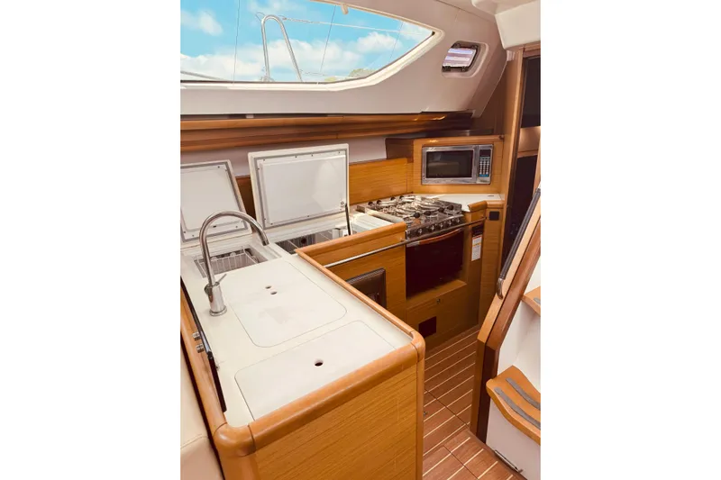 Bluefin Yacht Photos Pics 2008 Jeanneau Sun Odyssey 45 DS yacht kitchen with modern appliances and wood finish.