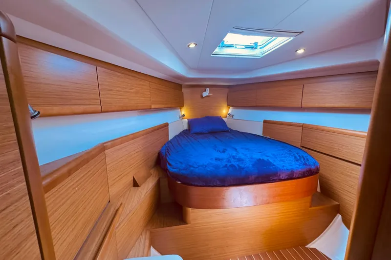 Bluefin Yacht Photos Pics Luxurious cabin interior of 2008 Jeanneau Sun Odyssey 45 DS sailboat with wood finish.