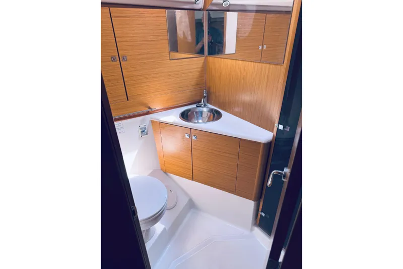 Bluefin Yacht Photos Pics Bathroom interior of 2008 Jeanneau Sun Odyssey 45 DS yacht, featuring wood cabinetry and modern fixtures.