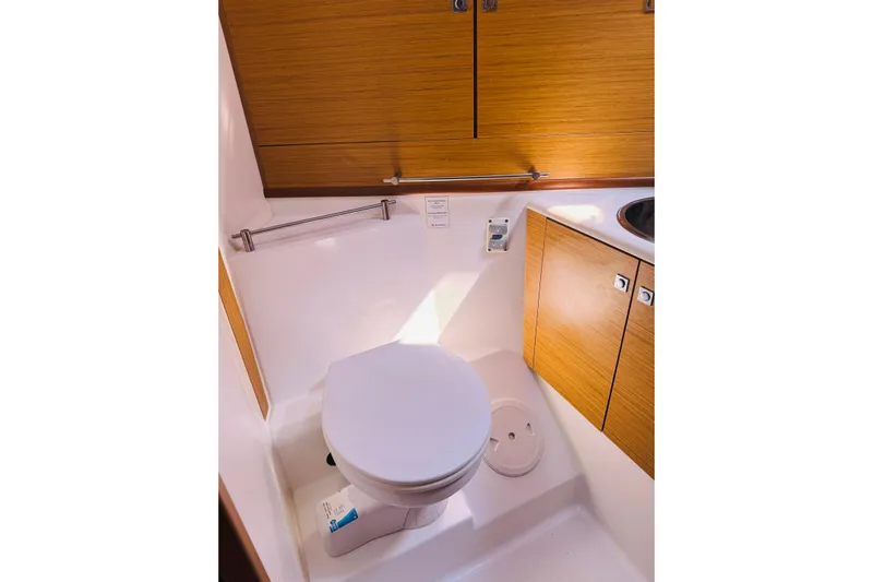 Bluefin Yacht Photos Pics Bathroom interior of 2008 Jeanneau Sun Odyssey 45 DS yacht, featuring wooden cabinetry.