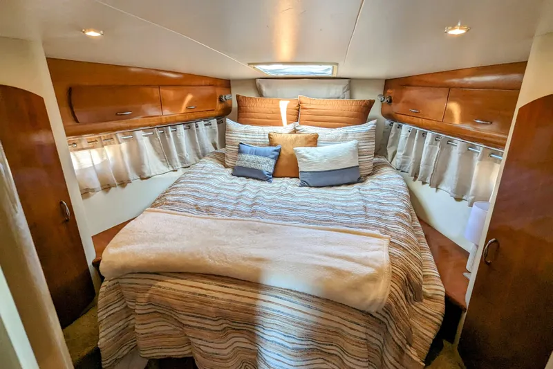  Yacht Photos Pics Luxurious 2004 Carver 360 Mariner cabin with cozy bed and elegant wood finishes.