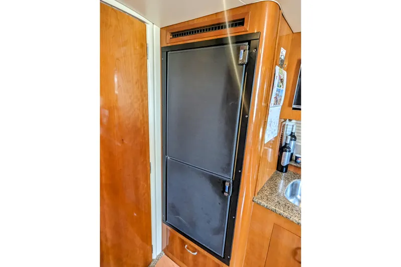  Yacht Photos Pics 2004 Carver 360 Mariner interior with wooden cabinetry and built-in refrigerator.