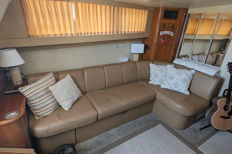  Yacht Photos Pics Interior of 2004 Carver 360 Mariner with leather sofa, pillows, and guitar.
