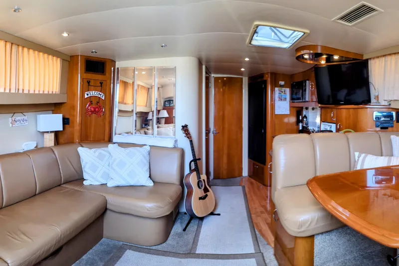  Yacht Photos Pics Interior of 2004 Carver 360 Mariner yacht with cozy seating and guitar.