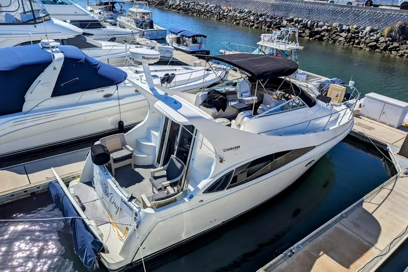 Yacht Photos Pics 2004 Carver 360 Mariner yacht docked at marina, featuring spacious deck and sleek design.