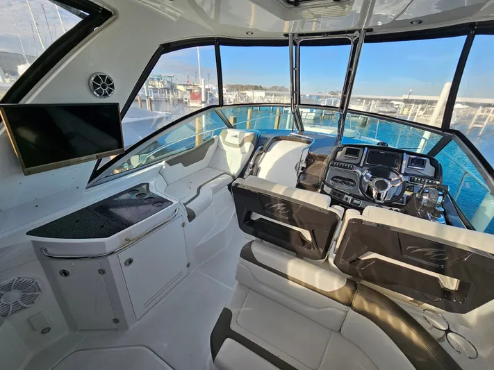 Second Half Yacht Photos Pics 2016 Monterey 355 Sport Yacht interior with helm, seating, and panoramic marina view.