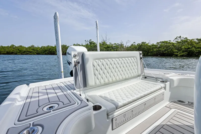  Yacht Photos Pics 2018 Barker Boatworks 26 Calibogue Bay with luxurious seating, on a serene water backdrop.