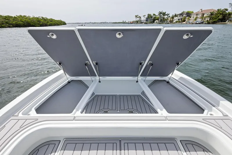  Yacht Photos Pics 2018 Barker Boatworks 26 Calibogue Bay with open storage compartments on calm water.
