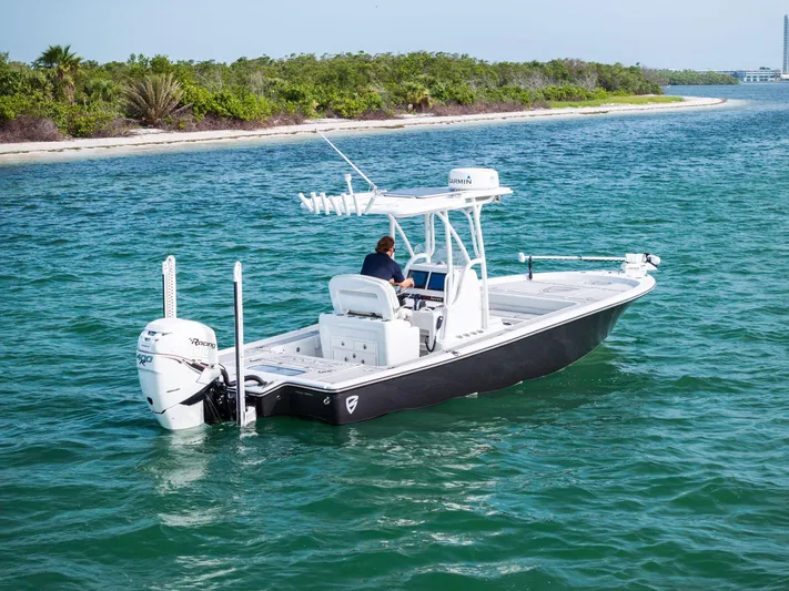  Yacht Photos Pics 2018 Barker Boatworks 26 Calibogue Bay cruising on clear blue water near a lush shoreline.