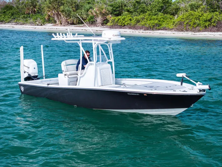  Yacht Photos Pics 2018 Barker Boatworks 26 Calibogue Bay on clear blue water near a sandy shore.