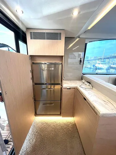 Rialtin Yacht Photos Pics Modern kitchen interior of 2022 Beneteau Monte Carlo 52 yacht with stainless steel appliances.