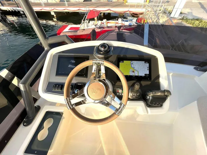 Rialtin Yacht Photos Pics Helm of 2022 Beneteau Monte Carlo 52 yacht with navigation screens and steering wheel.