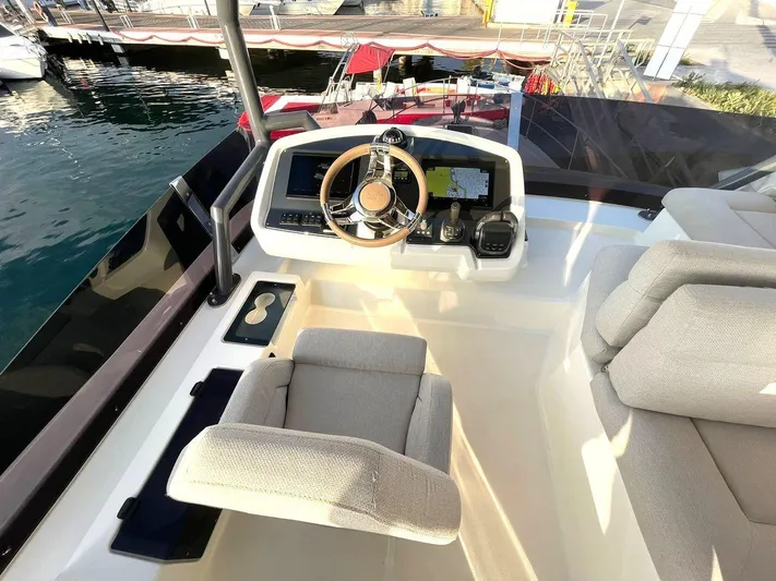 Rialtin Yacht Photos Pics Helm station of 2022 Beneteau Monte Carlo 52 yacht with modern controls and seating.