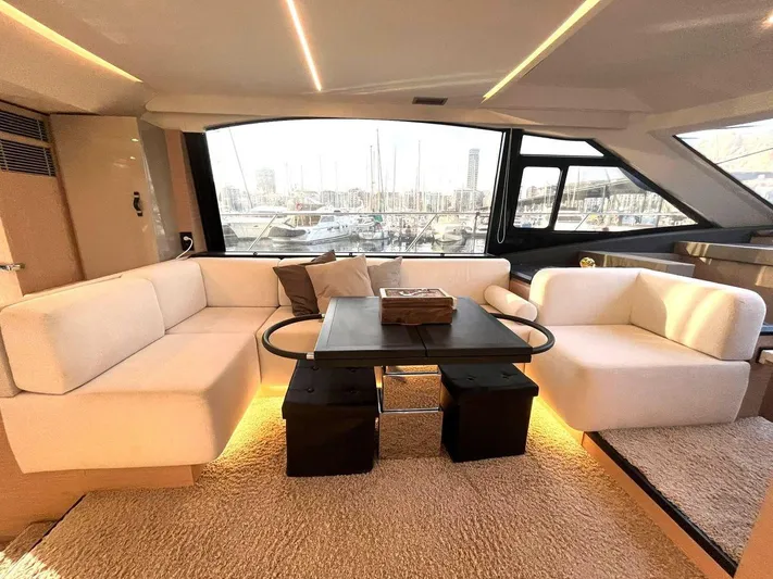 Rialtin Yacht Photos Pics Luxurious interior of 2022 Beneteau Monte Carlo 52 yacht with elegant seating and table.