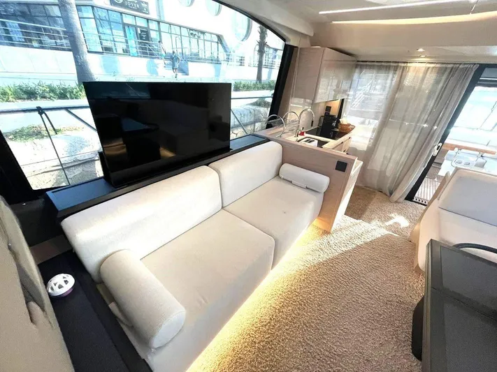 Rialtin Yacht Photos Pics Luxurious interior of 2022 Beneteau Monte Carlo 52 yacht with modern furnishings and large windows.