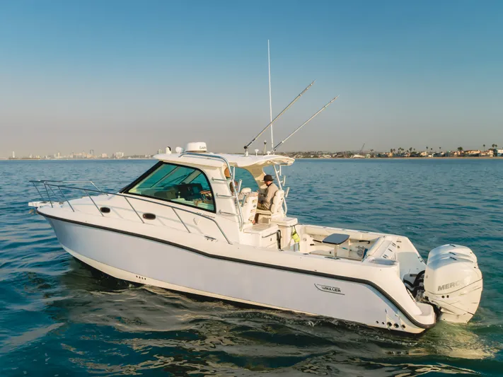 Giddy Up Yacht Photos Pics 2009 Boston Whaler 345 Conquest boat cruising on calm ocean waters.
