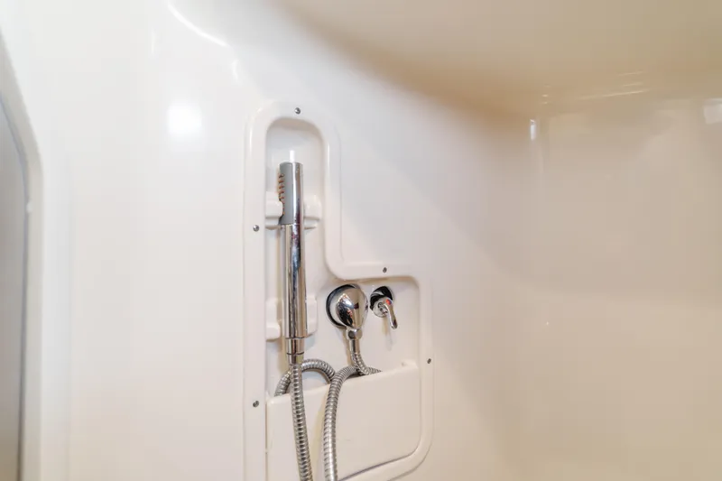 Giddy Up Yacht Photos Pics Shower area in 2009 Boston Whaler 345 Conquest boat, featuring chrome fixtures.