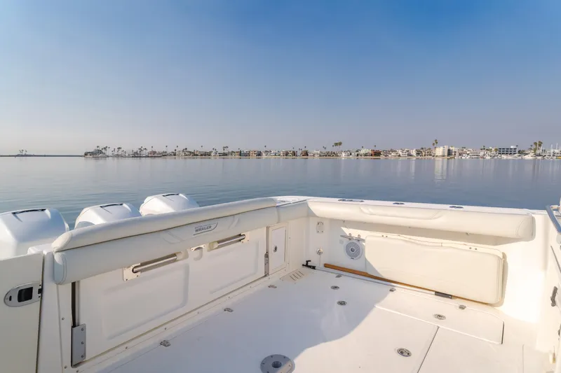Giddy Up Yacht Photos Pics 2009 Boston Whaler 345 Conquest boat deck with serene waterfront view.