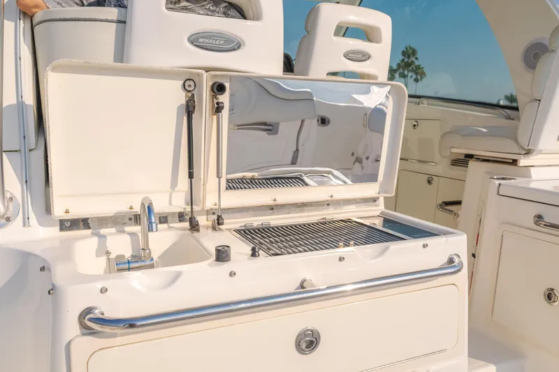 Giddy Up Yacht Photos Pics Boston Whaler 345 Conquest 2009 boat with open grill and sink on deck.