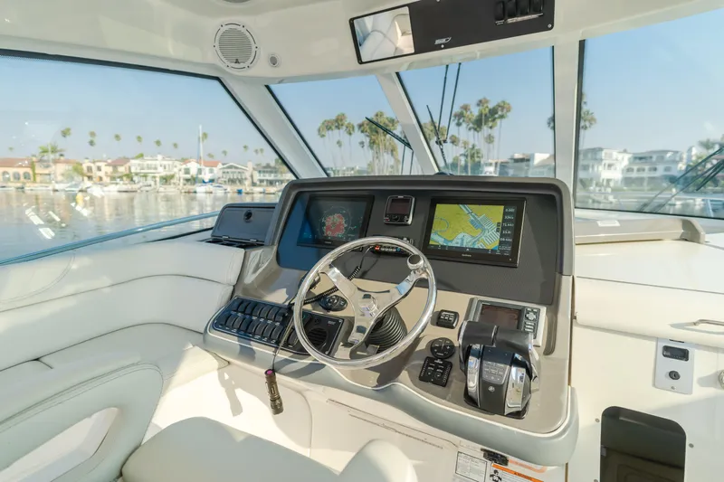 Giddy Up Yacht Photos Pics 2009 Boston Whaler 345 Conquest helm with navigation system and steering wheel.