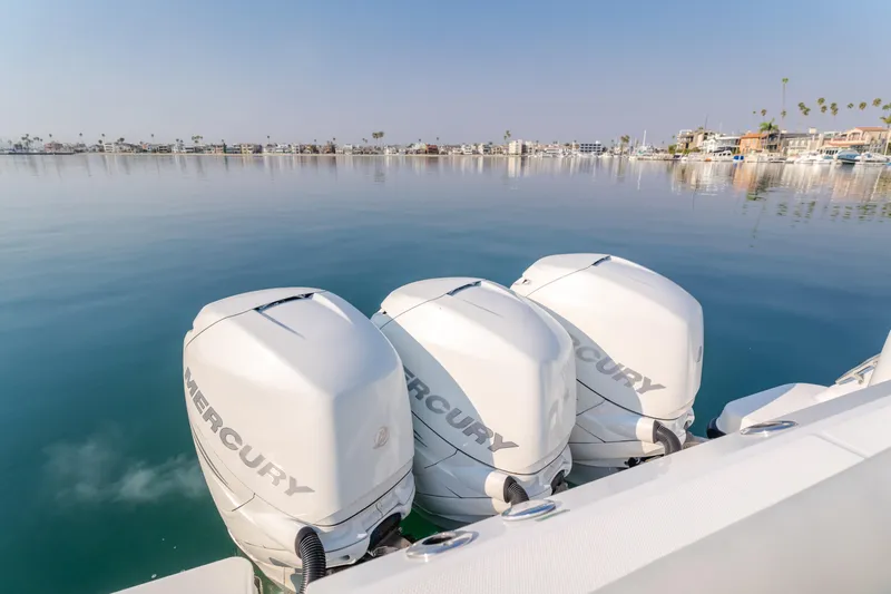 Giddy Up Yacht Photos Pics Boston Whaler 345 Conquest 2009 with triple Mercury outboard engines on calm water.