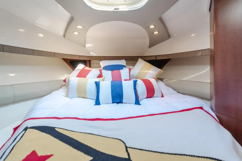 Giddy Up Yacht Photos Pics Luxurious cabin interior of 2009 Boston Whaler 345 Conquest with colorful pillows.