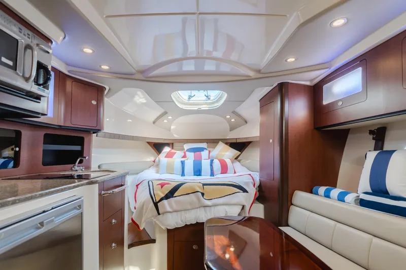 Giddy Up Yacht Photos Pics Luxurious interior of 2009 Boston Whaler 345 Conquest with cozy bed and modern amenities.
