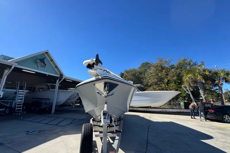  Yacht Photos Pics 2023 Fountain 34 Tournament Edition boat on trailer at marina under clear blue sky.