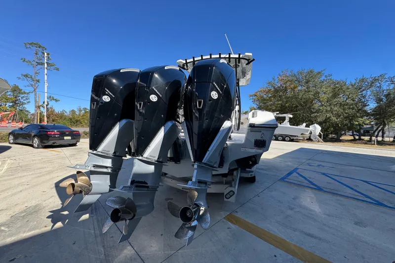  Yacht Photos Pics 2023 Fountain 34 Tournament Edition boat with triple outboard engines in a parking lot.